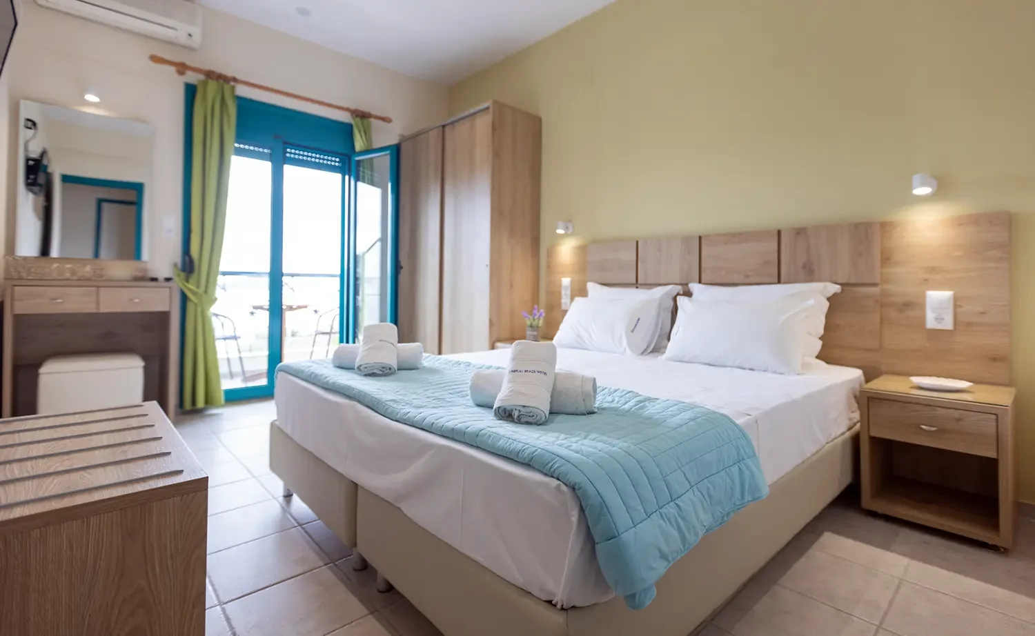 Double room with blue textiles and balcony doors